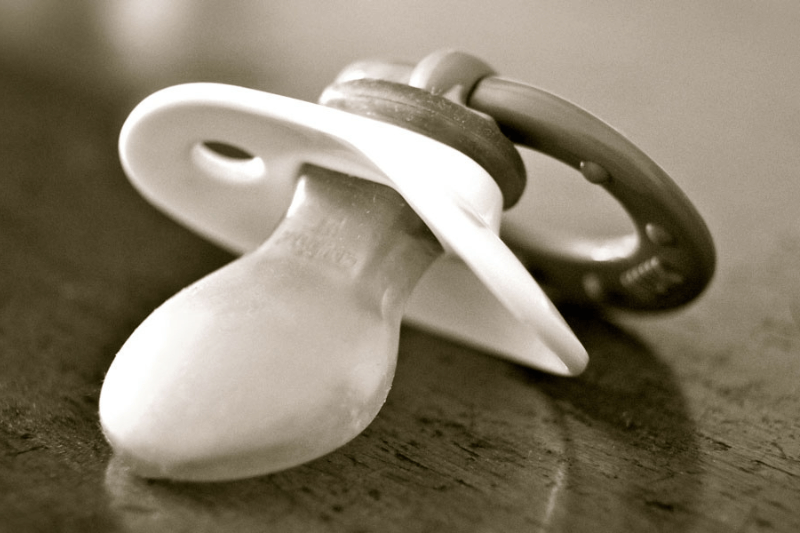 A sepia toned picture of a pacifier